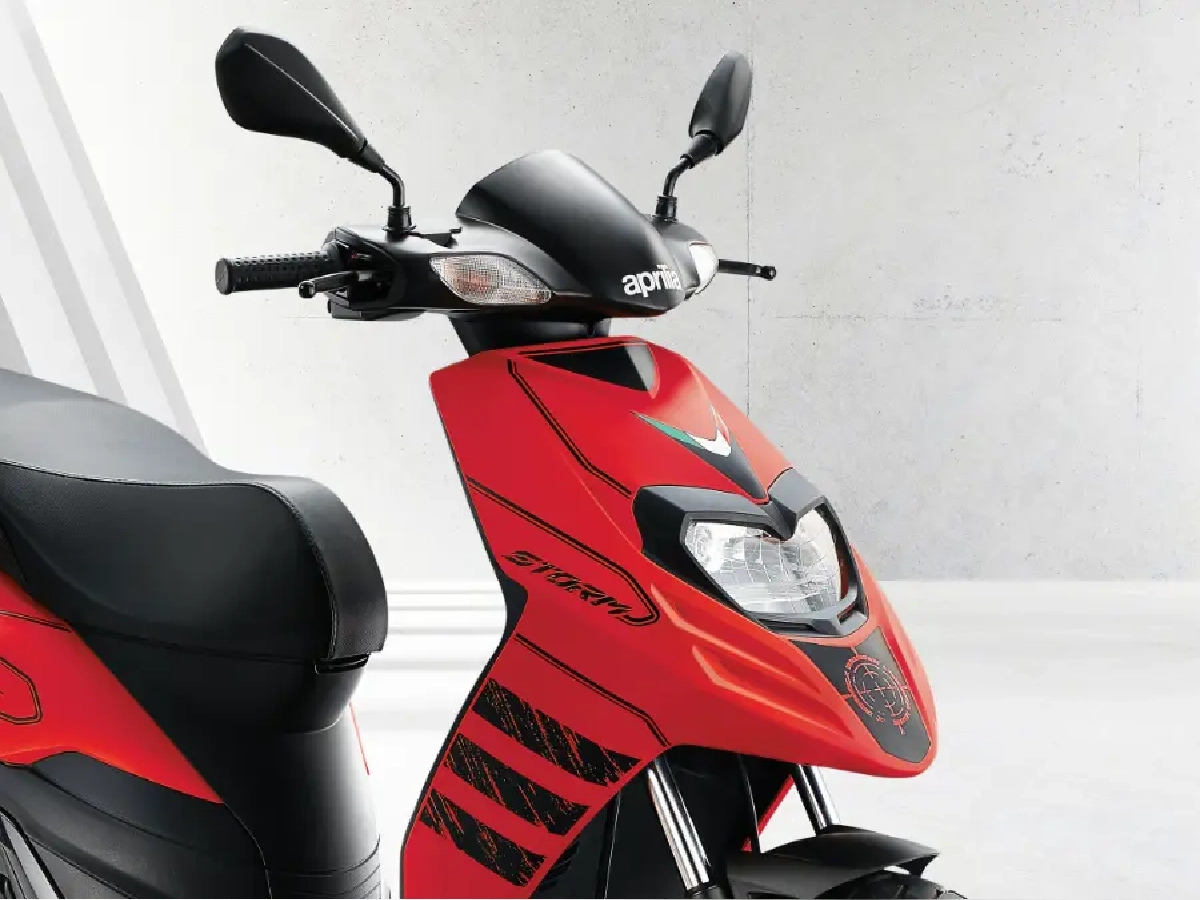 Front three quarter view of red Aprilia SR Storm 125 scooter