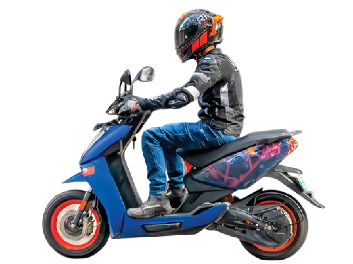 Rider sitting on Ather 450 Apex electric scooter side profile