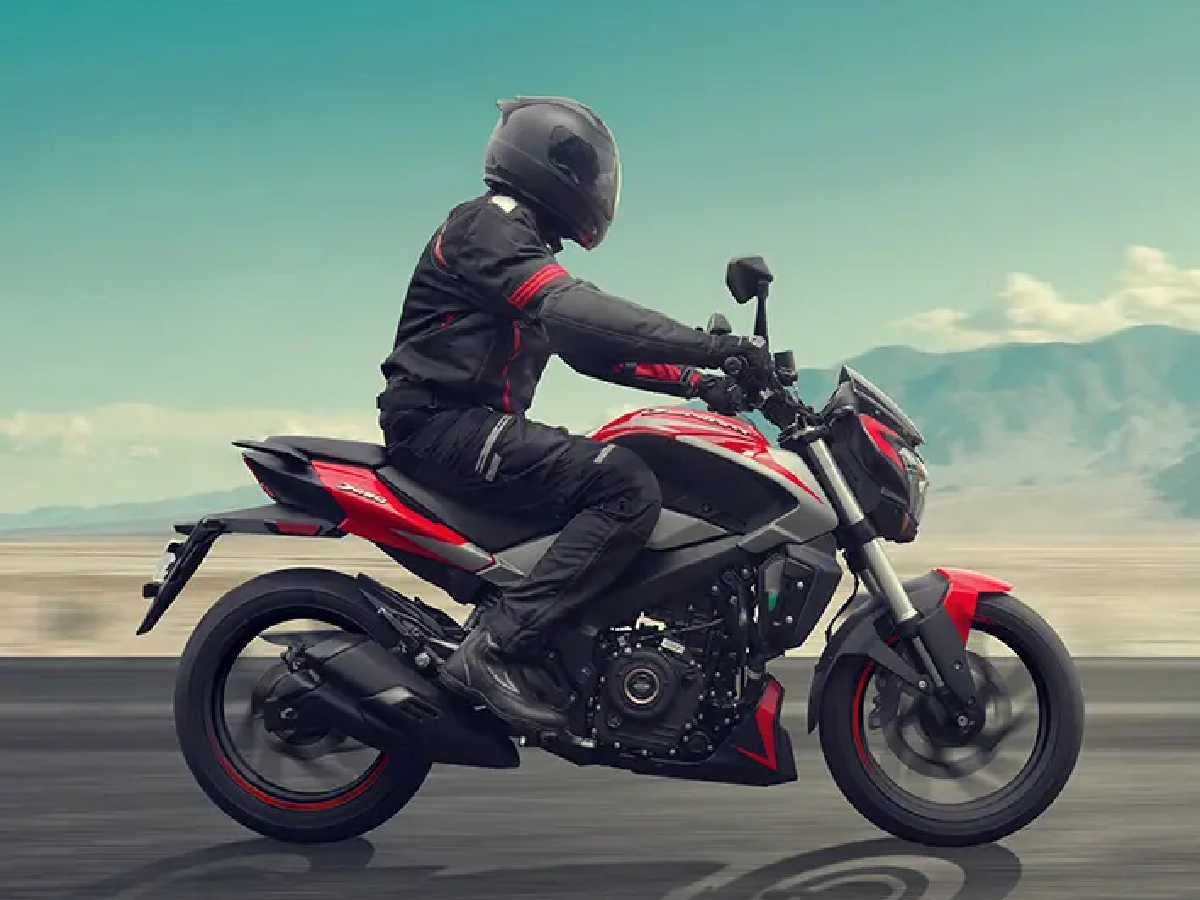 Rider on Bajaj Dominar 250 Canyon Red cruising on open road