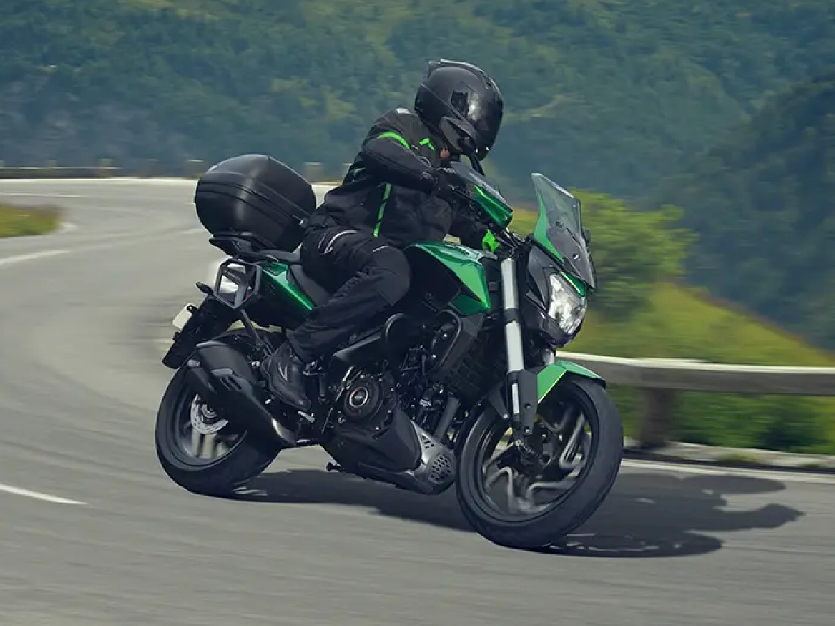 Rider leaning Bajaj Dominar 400 into a highway corner
