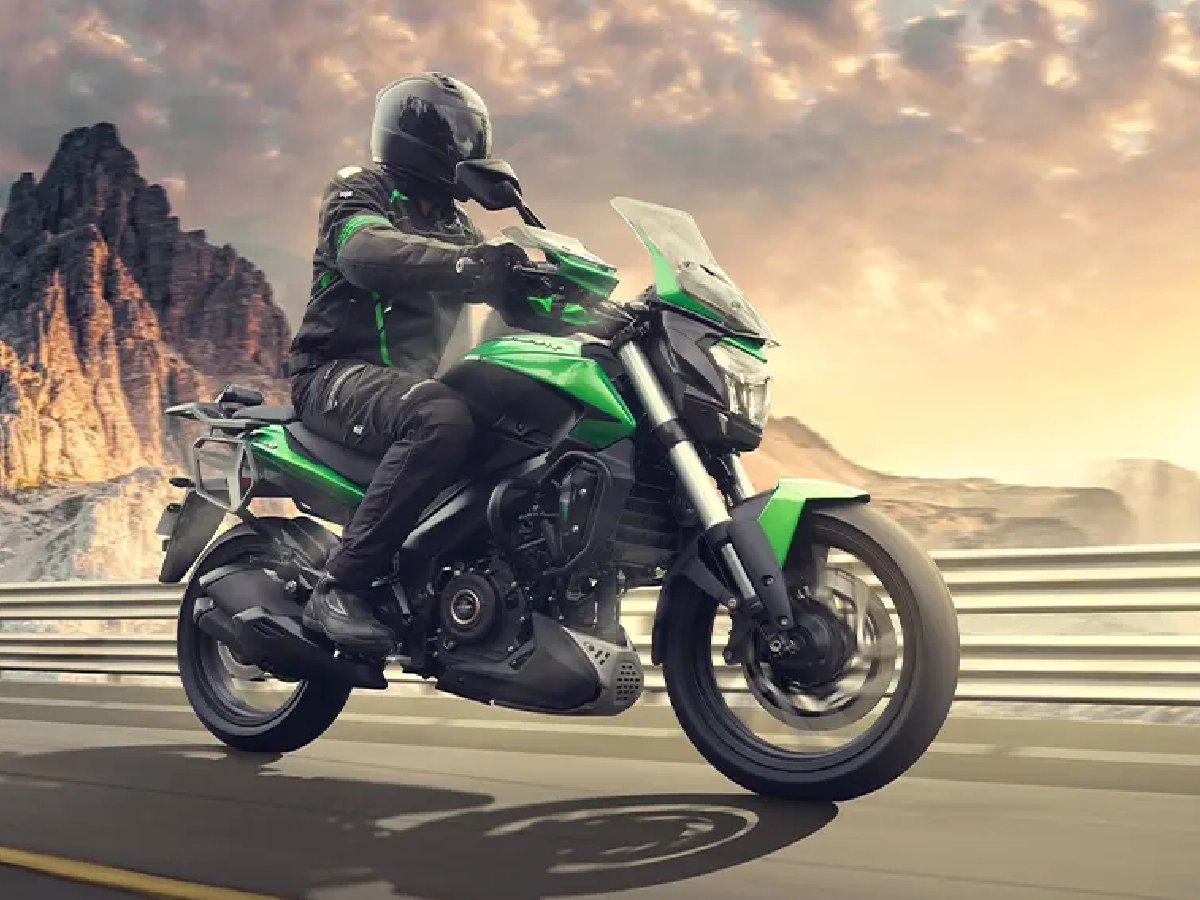 Rider cruising Bajaj Dominar 400 on mountain highway road