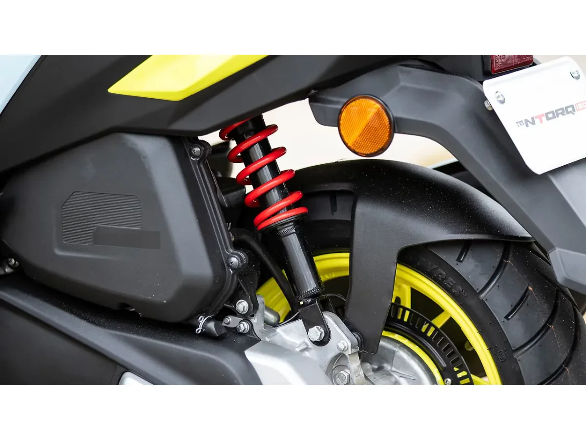 Close-up of the TVS Ntorq 150 air cleaner housing and rear wheel