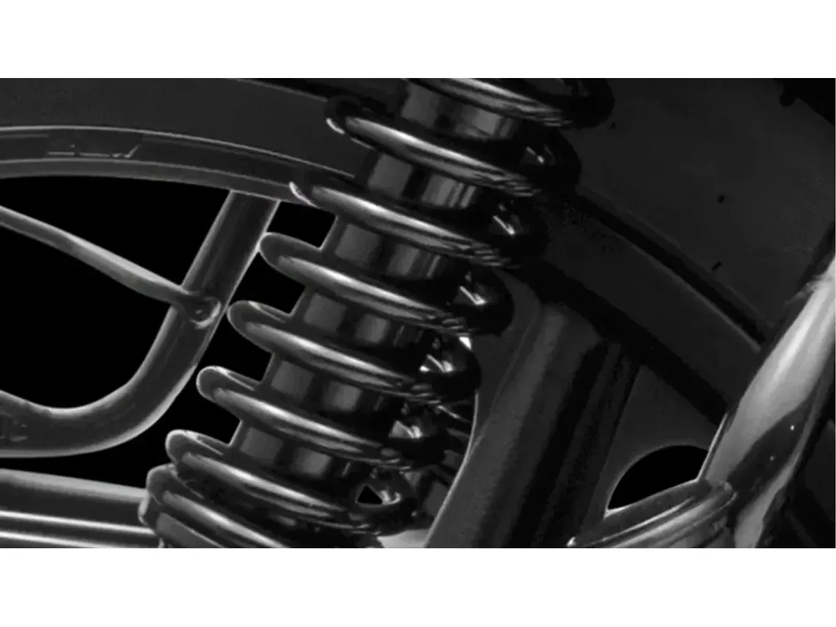 Rear suspension detail of the TVS Sport motorcycle