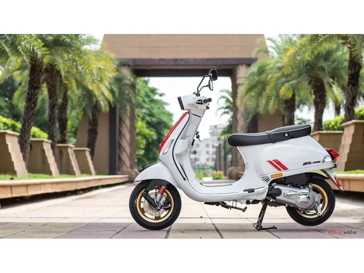 White Vespa SXL 150 shown from the left side outdoors