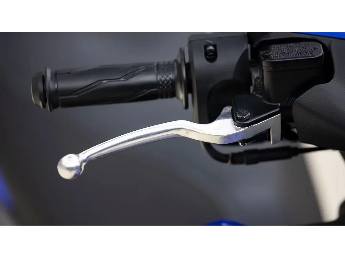 Close-up of the Yamaha Aerox 155 front brake lever and handlebar