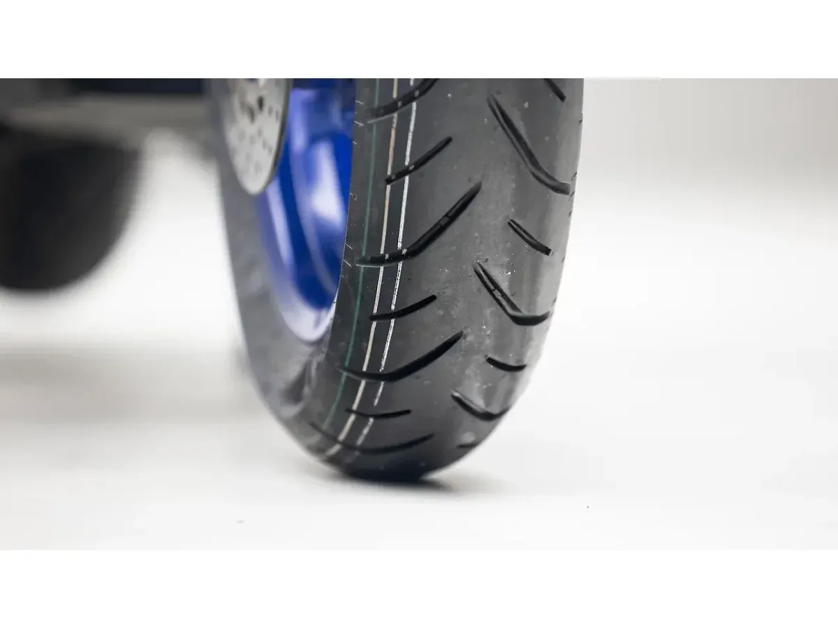 Close-up of the Yamaha Aerox 155 front tyre and wheel