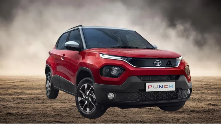 Red Tata Punch compact SUV showcased on rugged terrain with bold front grille, LED DRLs, and sporty alloy wheels.